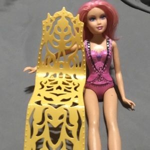 One Barbie doll with a golden yellow chair